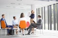 Businesswoman planning strategy with colleagues during meeting at office