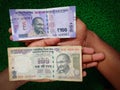 New and old Indian hundred rupees note placed in human hand.