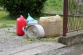 New and old plastic fuel canisters with plastic funnel next to used wide fire hose prepared for using with water pump to prevent Royalty Free Stock Photo