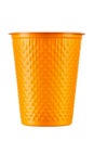 New orange plastic cup on white background. Disposable tableware Royalty Free Stock Photo