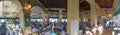 NEW ORLEANS, LA - FEBRUARY 2016: Tourists and locals have breakfast at Cafe Du Monde - Panoramic view Royalty Free Stock Photo