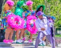 Costumed Women of Baby Dolls Marching Club and a Well-Dressed Man