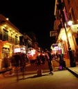 New Orleans, LA - USA - 03-20-2024: A crowd of people walk on busy Bourbon St at night in the French Quarter