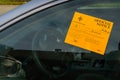 Official Notice of Abandoned-Junked Vehicle on the Driver Side Window of a Car