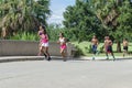 Girls and Boys Running in City Park