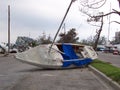 A small sailboat wrecked on a road, thrown inland by Hurricane Katrina