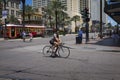 Street scene at Canal Street with a man on a bicycle in the downtown of the city of New Orleans, Louisiana