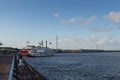 View of the Mississippi river from the city of New Orleans riverfront, with a Mississippi Steamboat on the background, in New Orle