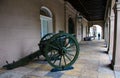 Old cast-iron cannon near the museum on the street in New Orleans. Cityscape