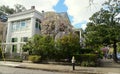 New Orleans, Louisiana, U.S.A - February 4, 2020 - Beautiful mansion with pink magnolia trees by The Garden District Royalty Free Stock Photo