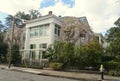 New Orleans, Louisiana, U.S.A - February 4, 2020 - Beautiful mansion with pink magnolia trees by The Garden District Royalty Free Stock Photo