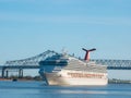 New Orleans, Louisianna, USA. Giant cruise ship sails past New Orleans on the Mississippi River. Crowds on deck waving