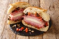 New Orleans Muffuletta Sandwich a monster of a sandwich piled high with multiple types of meat and cheese, and a perky olive salad