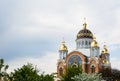 New orthodox church with golden domes in with blooming trees, build in 1990`s in Kiev, the capital of Ukraine Royalty Free Stock Photo