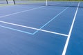 New outdoor blue tennis court with white lines combined with light blue pickleball lines