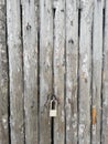 New padlock on an old wooden door. Vertical format. Royalty Free Stock Photo