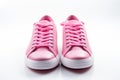 New pair of pink woman sneakers on white background. Lifestyle, sneaker sport shoe. Front view Royalty Free Stock Photo