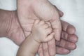 New parent holds his newborn infant baby`s hand for the first time. Parent holding newborns hand. Hand in hand. Parenthood. Mother Royalty Free Stock Photo
