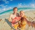 New parents cherish a beach day with their newborn a heartwarming family moment by the shore