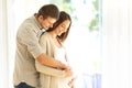 New parents looking at belly of pregnant mother Royalty Free Stock Photo