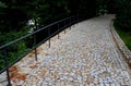 A new park path made of irregular cubes, folded with a side channel for draining water from the road surface. granite stones of Royalty Free Stock Photo
