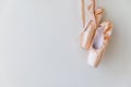 New pastel beige ballet shoes with satin ribbon isolated on white background. Ballerina classical pointe shoes for dance
