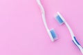 New pink and blue toothbrush on pink background with copy space for text or design Royalty Free Stock Photo
