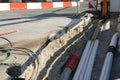 New pipes laid in a civil engineering shaft in the street with vertical and horizontal barrier planks