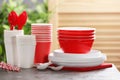 New plastic dishware on table against blurred background