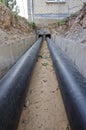 New plastic modern heating pipes in trench near city house