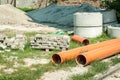 New plastic water pipes for city pipeline system paving tiles concrete blocks for sewerage and pile of sand and gravel on the stre