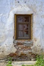 A new plastic window in an old brick wall with crumbling plaster Royalty Free Stock Photo