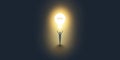 New Possibilities, Hope, Dreams - Man Standing In the Dark in Front of a Glowing Light Bulb