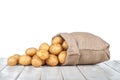 New potatoes in a bag on a white wooden table on isolated on a w