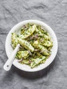 New potatoes, gherkins, red onions, french mustard olive oil dressing salad on a grey background, top view Royalty Free Stock Photo