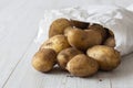 New potatoes in a white paper bag, environmentally friendly biodegradable packaging Royalty Free Stock Photo