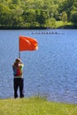 Woman Raising Finishing Flag at Regatta