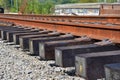 New railroad section ready for installation. Brand new wooden ties covered with creosote. Royalty Free Stock Photo