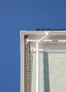 New rain gutter on a brick wall against blue sky. Royalty Free Stock Photo