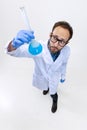 Close-up young chemist, doctor or student conducts chemical research isolated on white background. Concept of Royalty Free Stock Photo