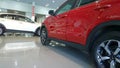 New red car at auto dealership. Automobile purchase sale insurance. Automotive industry crisis and development concept.