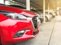 TheÃ¢â¬â¹ new red car in the parked with many cars on parking lot Royalty Free Stock Photo