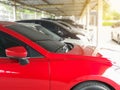 TheÃ¢â¬â¹ new red car in the parked with many cars on parking lot Royalty Free Stock Photo