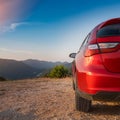 A new red car pulled over on the side of a remote mountain road Royalty Free Stock Photo