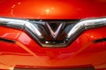 new red electric Vinfast electric car in showroom, Logo on cap, trends EV in Europe, technological advancements automotive