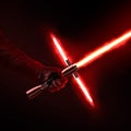 New red light saber holdng in hand close-up isolated on black.