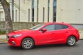New red Mazda 3 parked