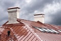 New red metal roof with skylights in rain