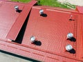 New red metal warehouse roof with installed pipes of ventilation