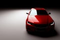 New red metallic sedan car in spotlight. Modern desing, brandless. Royalty Free Stock Photo